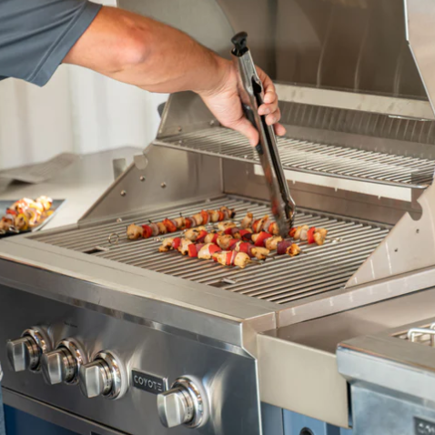 man grilling after budgeting costs for an outdoor kitchen