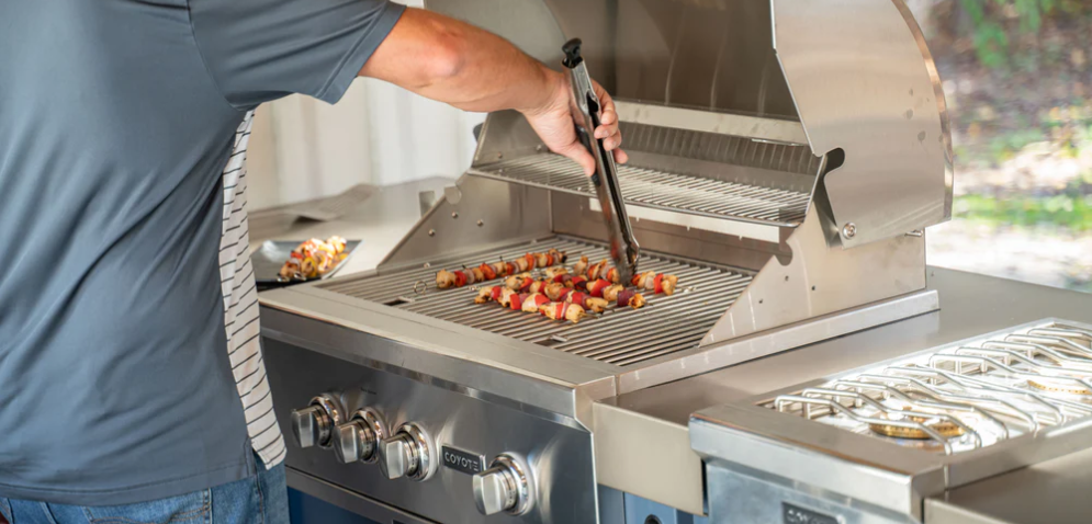 man grilling after budgeting costs for an outdoor kitchen