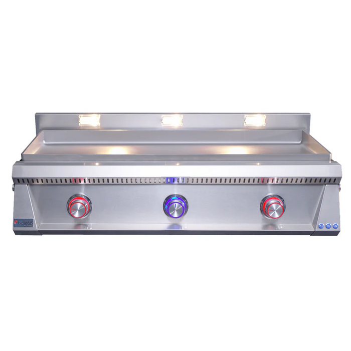 Stono Outdoor Living The Le Griddle Pro Series 105 by Le Griddle is a stainless steel, commercial-grade gas griddle with 3 burners (natural gas), two red and one blue control knobs, interior lights, a raised backsplash, and a 6mm plate (model OML105P6).
